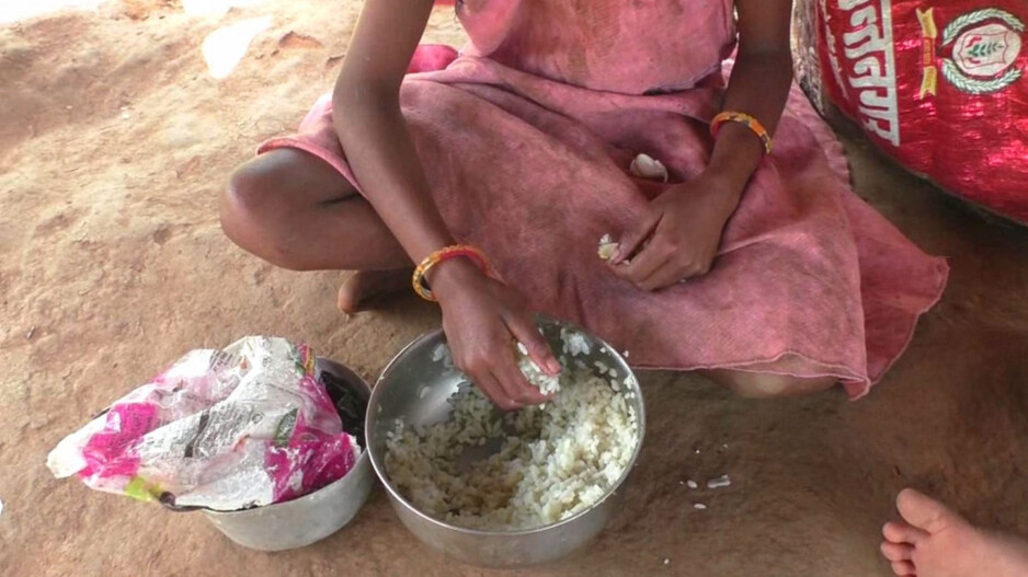 Children are eating rice with salt