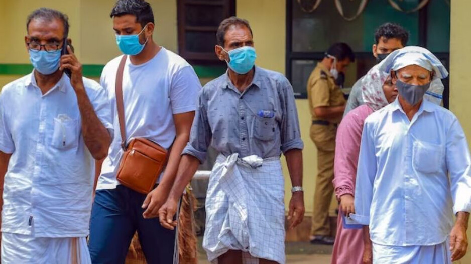 People wear masks at a medical college after the Nipah virus alert in Kozhikode