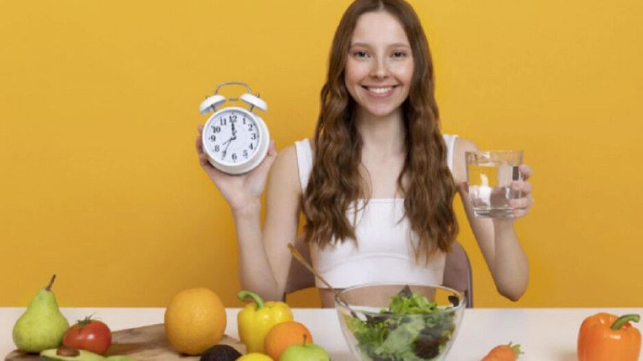 A girl showing watch & water glass 