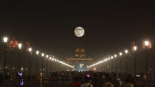 The supermoon appears above the India Gate