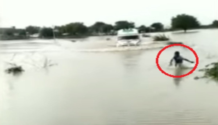12 yerars boys show road while flood