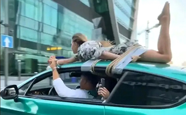 girlfriend-on car roof